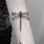 Dragonfly tattoo on the forearm