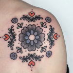 Floral ornament tattoo on the shoulder