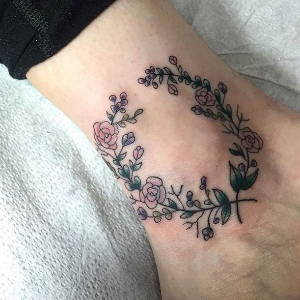 Floral wreath tattoo on the inner ankle