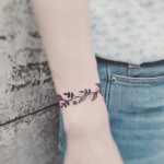 Floral wristband on the right arm