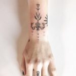 Flower black ornament tattoo on the wrist