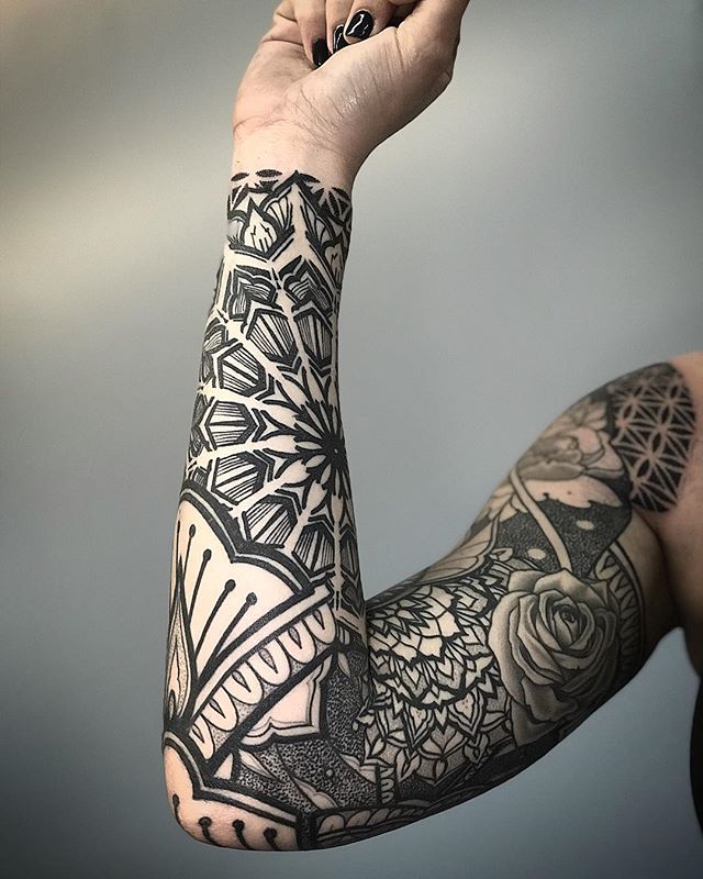 Full sleeve black pattern tattoo