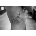 Geometric wolf tattoo on the rib cage