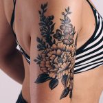 Gorgeous black and grey flowers on the upper arm