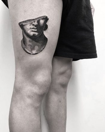 Half of greek head bust tattoo