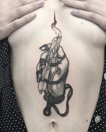 Hand and candle tattoo