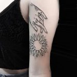 Hand and sun tattoo