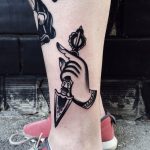 Hand with an arrow tattoo
