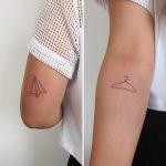 Hanger and paper airplane tattoo
