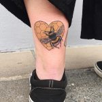 Heart shaped honeycomb and bee tattoo