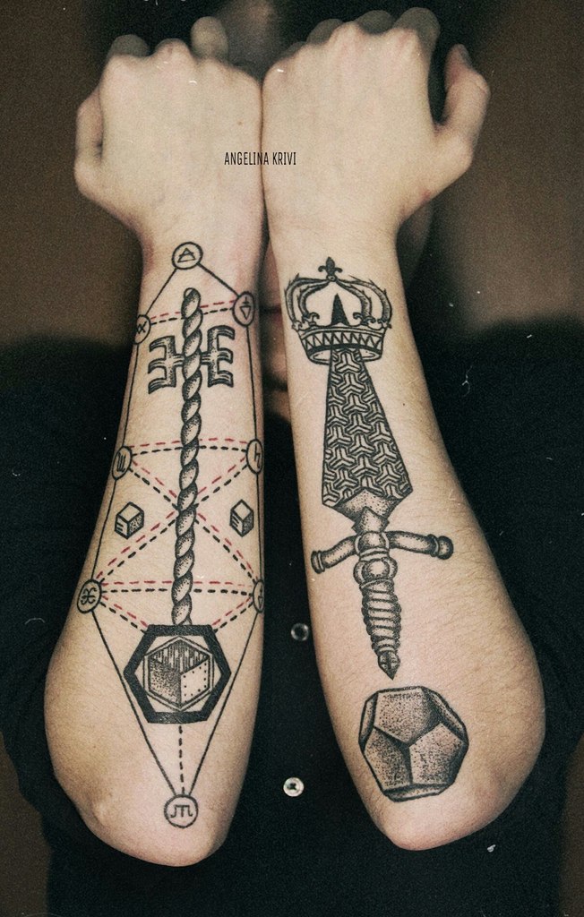 Key and dagger tattoos on forearms