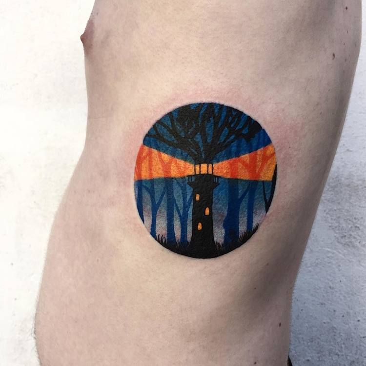 Lighthouse in a circle tattoo