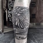Linear landscape tattoo on the calf