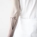 Linear paper airplane tattoo