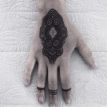 Lovely black ornament tattoo on the hand
