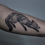 Lying black fox tattoo
