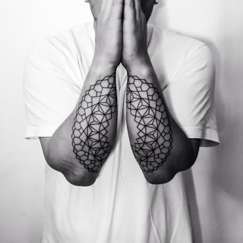 Matching black geometric mandala tattoo