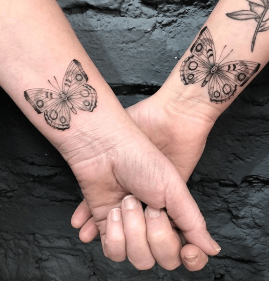 Matching butterfly tattoos on the wrists