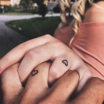 Matching tiny heart tattoos on fingers