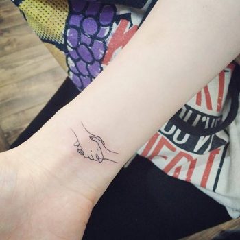 Minimalist handshake tattoo