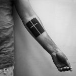 Negative space cross tattoo