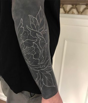 Negative space flower tattoo on the black background