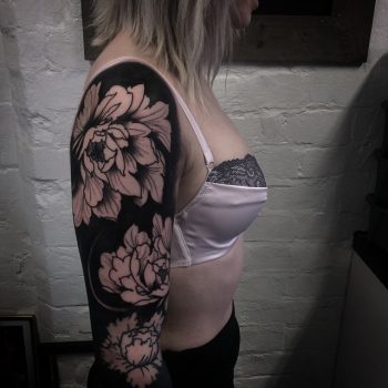 Negative space full sleeve flower tattoo