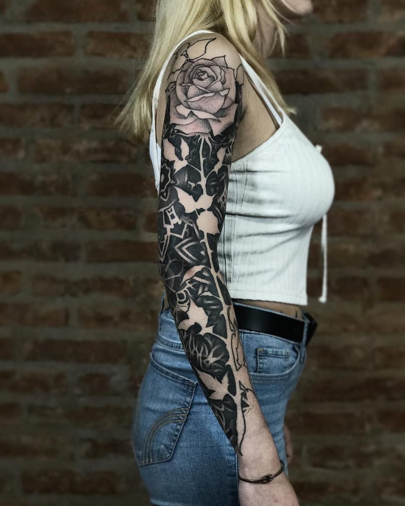 Negative space full sleeve rose tattoo