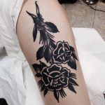 Negative space rose bundle tattoo