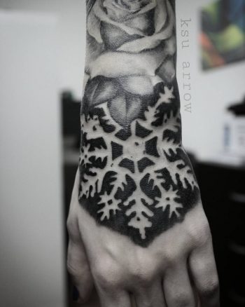 Negative space snowflake tattoo
