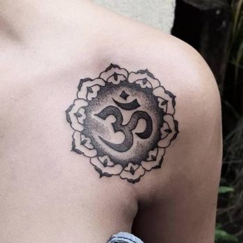 Om tattoo on the collarbone