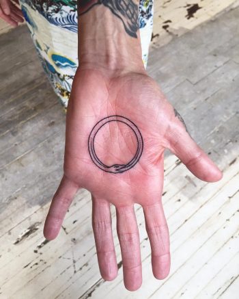 Ouroboros palm tattoo