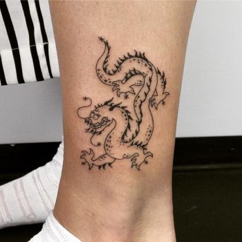 Outline dragon tattoo on the ankle