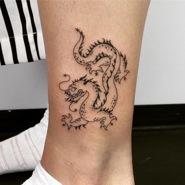 Outline dragon tattoo on the ankle - Tattoogrid.net