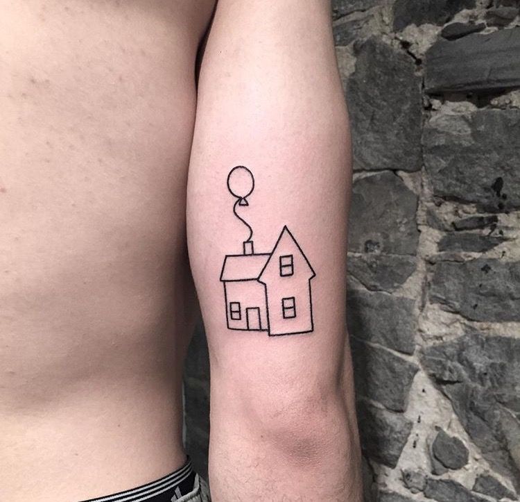 Fine line house stamp tattoo located on the bicep.