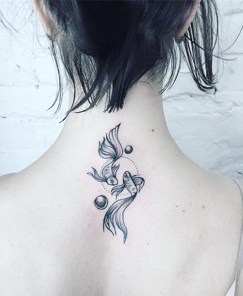 Pisces tattoo on the upper back