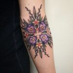 Purple flowers tattoo on the arm
