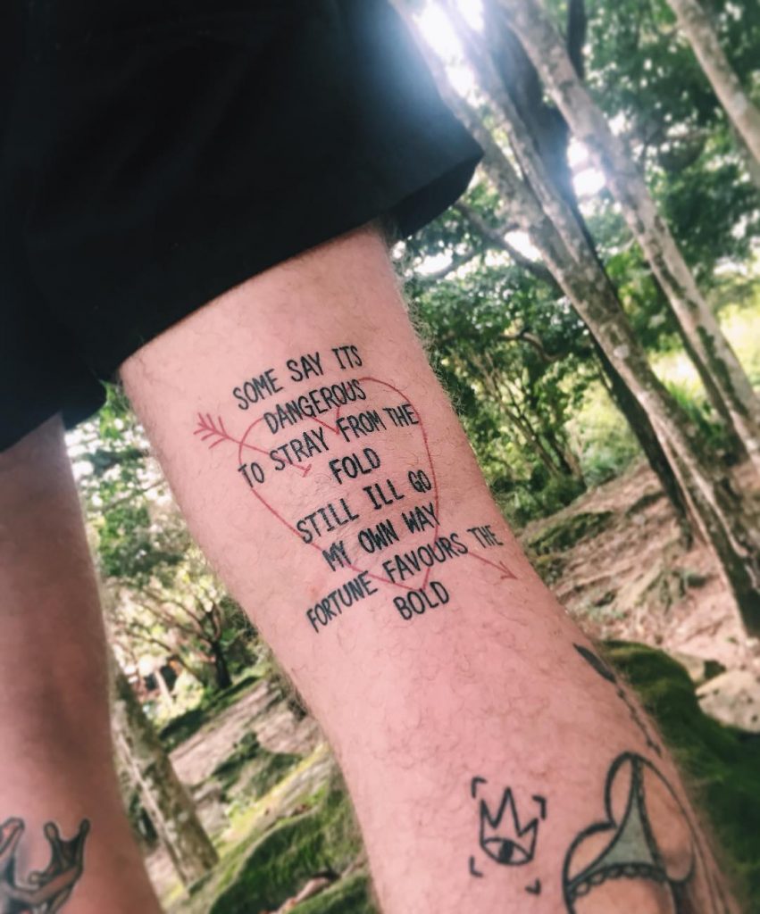 Quote tattoo on the thigh 