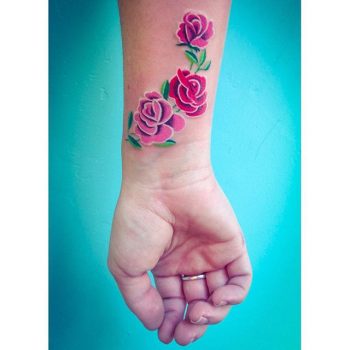Realistic pink rose tattoo on the wrist
