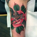 Red rose with green leaves tattoo
