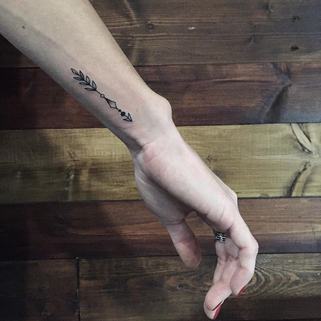 Simple arrow forearm tattoo
