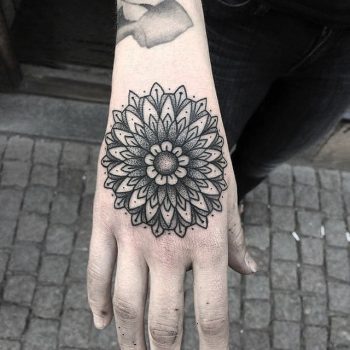 Simple black mandala on the hand