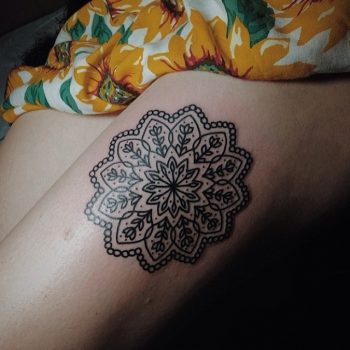 Simple black mandala tattoo on the shin