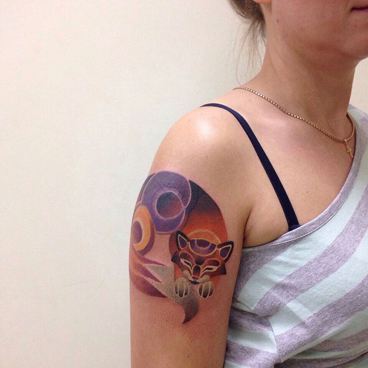 Sleeping cat tattoo on the arm