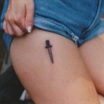 Small black dagger on the upper thigh