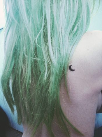 Small crescent moon tattoo on the back