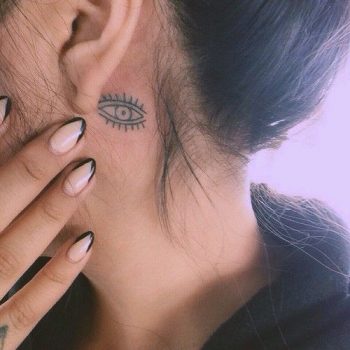 Small eye behind the ear tattoo