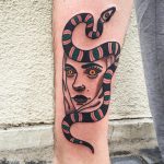 Snake and woman face tattoo