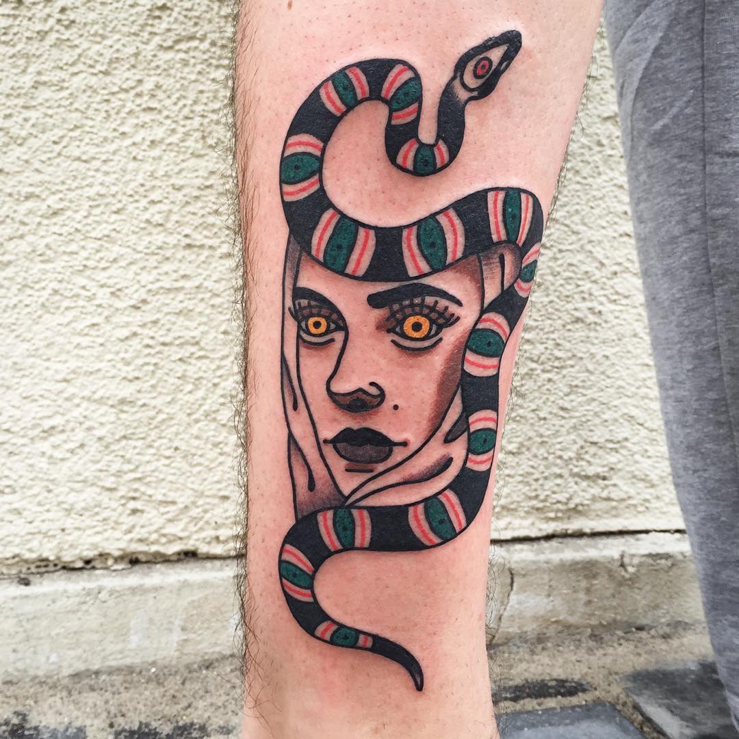 Snake and woman's face tattoo