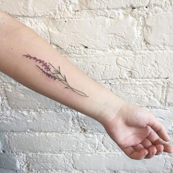 Subtle purple flower on the forearm